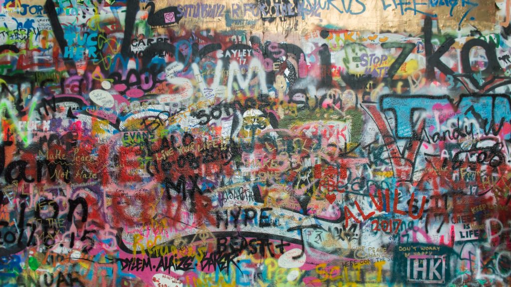 A wall covered in lots of graffiti