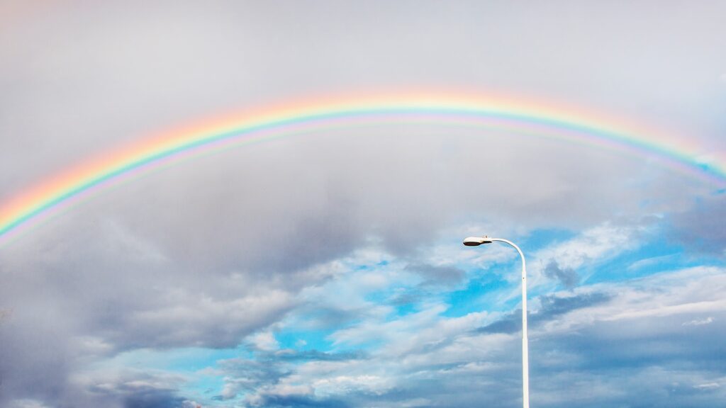 Rainbow over a street light.